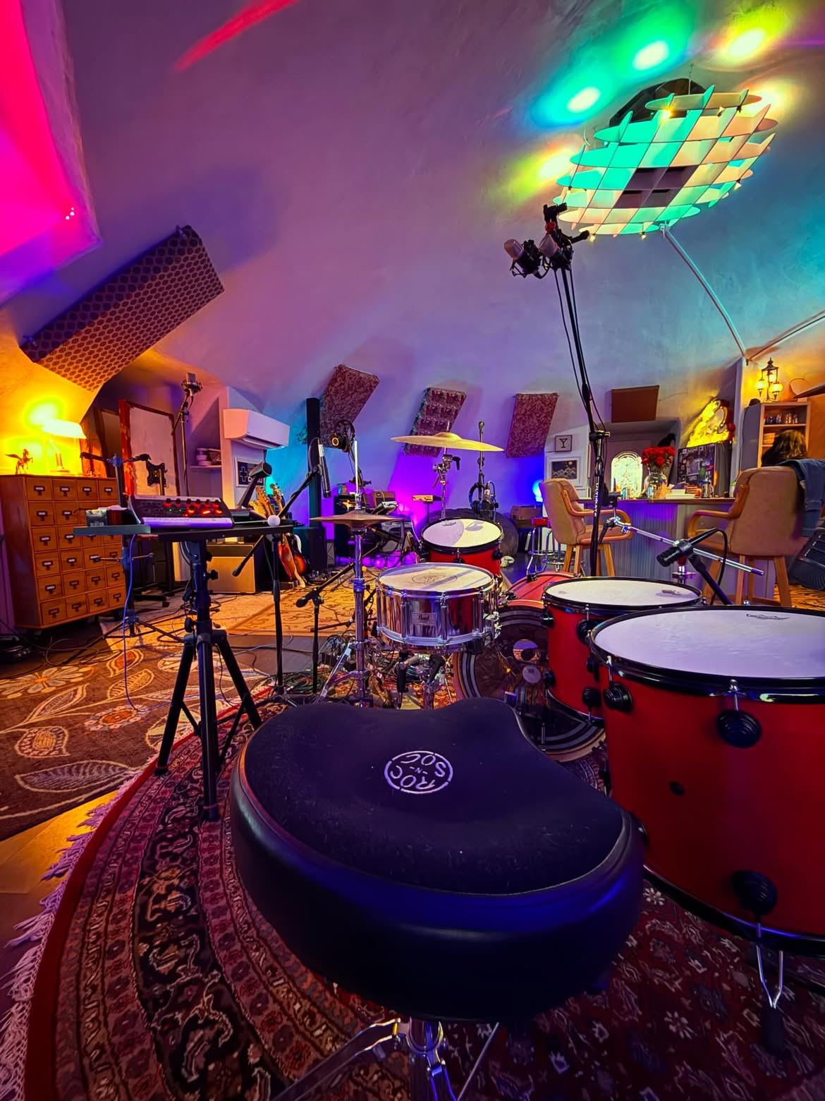 Inside the concrete dome live room — drum kit, disco ball and technicolor lights at The Dome Collective recording studio near Las Vegas